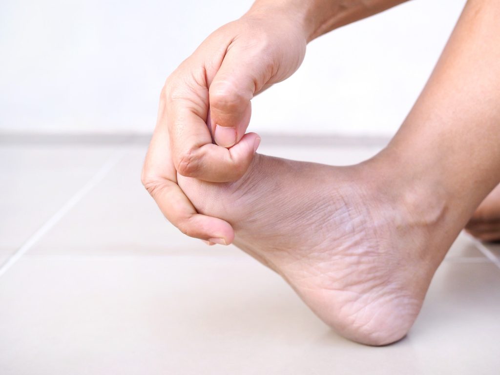 Symptom foot pain and numbness in feet of adult women or ache from bunion disease or plantar